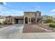 Two-story home showcasing a well-manicured front yard with desert landscaping and an extended driveway at 3777 E Latham Ct, Gilbert, AZ 85297
