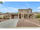 Two-story home showcasing a well-manicured front yard with desert landscaping and an extended driveway at 3777 E Latham Ct, Gilbert, AZ 85297