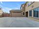 Spacious three car garage with a basketball hoop with a well-maintained driveway and side entrance at 3777 E Latham Ct, Gilbert, AZ 85297