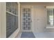 A close up of the front door entrance with modern design door and storm door with adjacent windows at 3777 E Latham Ct, Gilbert, AZ 85297