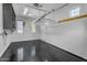 Well-lit garage with epoxy flooring, overhead lighting and storage racks at 3777 E Latham Ct, Gilbert, AZ 85297