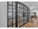 Hallway view showing arched glass French doors to an office and a view to the formal living room at 3777 E Latham Ct, Gilbert, AZ 85297