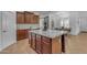 Well-lit kitchen showcasing an island with granite countertop and elegant wooden cabinets at 3777 E Latham Ct, Gilbert, AZ 85297