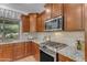 Kitchen view of granite countertops and stainless steel stove with overhead microwave at 3777 E Latham Ct, Gilbert, AZ 85297