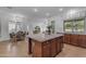 Spacious kitchen featuring a large island with granite countertops and wooden cabinetry at 3777 E Latham Ct, Gilbert, AZ 85297