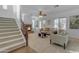 Bright living room boasts a fireplace, staircase, and neutral-toned furniture at 3777 E Latham Ct, Gilbert, AZ 85297