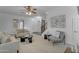 Open concept living room with light filled windows and neutral color palette at 3777 E Latham Ct, Gilbert, AZ 85297