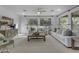 Bright living room featuring neutral-colored sofas, plush pillows, and two large windows at 3777 E Latham Ct, Gilbert, AZ 85297