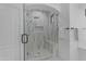 Modern walk-in shower with frameless glass door, bench, and a rainfall shower head at 3777 E Latham Ct, Gilbert, AZ 85297