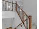 Elegant staircase with carpeted steps, wood handrails, and decorative iron spindles at 3777 E Latham Ct, Gilbert, AZ 85297