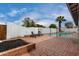 Backyard featuring brick patio, sparkling pool, and secure fencing at 3832 W Eva St, Phoenix, AZ 85051