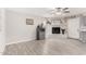 Bright and airy living room with wood-look tile flooring and a charming fireplace at 3832 W Eva St, Phoenix, AZ 85051