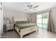 Light-filled main bedroom with ceiling fan and access to the pool at 3832 W Eva St, Phoenix, AZ 85051