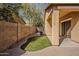 Side yard with grass and neutral stucco exterior at 3894 E Palmer St, Gilbert, AZ 85298