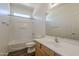 Clean bathroom featuring a shower-tub combo, wood-look flooring and a vanity with storage at 3894 E Palmer St, Gilbert, AZ 85298