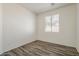 Bedroom with wood-look floors, neutral walls, and bright natural light at 3894 E Palmer St, Gilbert, AZ 85298