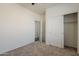 Bedroom features neutral carpet, a ceiling fan, and a closet with sliding doors at 3894 E Palmer St, Gilbert, AZ 85298