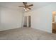 Comfortable bedroom with ceiling fan, carpeted floor, and natural light from window at 3894 E Palmer St, Gilbert, AZ 85298