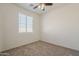 Inviting bedroom with a cozy carpet, bright natural light, and a ceiling fan at 3894 E Palmer St, Gilbert, AZ 85298