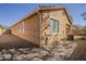 Rear exterior view shows the backyard of the home with an AC unit and gravel at 3894 E Palmer St, Gilbert, AZ 85298