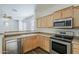 Well-appointed kitchen with stainless steel appliances and an open view to the living area at 3894 E Palmer St, Gilbert, AZ 85298
