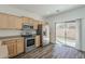 This open kitchen boasts stainless steel appliances, wood cabinets, and easy access to outdoor patio at 3894 E Palmer St, Gilbert, AZ 85298