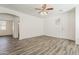 Sun-filled living room with wood-look tile and view to the front door at 3894 E Palmer St, Gilbert, AZ 85298