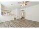 Bright living room with wood-look tile flooring and modern ceiling fan fixture at 3894 E Palmer St, Gilbert, AZ 85298