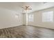 Sun-filled living room with neutral walls, wood-look tile and many windows at 3894 E Palmer St, Gilbert, AZ 85298