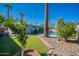 Backyard featuring artificial turf, in-ground pool, and desert landscaping at 406 W Flower St, Phoenix, AZ 85013