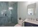 Modern bathroom with a tiled shower, toilet, and vanity with storage at 406 W Flower St, Phoenix, AZ 85013