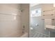 Bright bathroom featuring white tile, geometric flooring, and natural light from the window at 406 W Flower St, Phoenix, AZ 85013