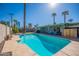 Sparkling blue backyard pool with surrounding patio and palm trees at 406 W Flower St, Phoenix, AZ 85013