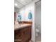 Bathroom with wood cabinets, granite countertops, mosaic backsplash, and a blue towel at 41353 N 106Th St, Scottsdale, AZ 85262