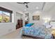 Bedroom featuring a ceiling fan, a window with mountain views, and neutral carpeting at 41353 N 106Th St, Scottsdale, AZ 85262