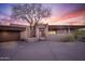 Desert home at sunset with drought tolerant desert landscaping and a circular driveway leading to the front entrance at 41353 N 106Th St, Scottsdale, AZ 85262