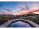 Hot tub overlooking Arizona desert landscape with a colorful sunset at 41353 N 106Th St, Scottsdale, AZ 85262