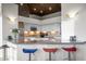 Kitchen with granite countertops, stainless appliances, and a breakfast bar with colorful stools at 41353 N 106Th St, Scottsdale, AZ 85262