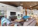Spacious living room showcasing a fireplace, rich wood ceilings, plush seating, and an open concept layout at 41353 N 106Th St, Scottsdale, AZ 85262