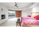 Spacious bedroom with a fireplace, patio access, and neutral color scheme at 41353 N 106Th St, Scottsdale, AZ 85262
