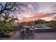 Outdoor patio featuring a dining set and spa, set against a backdrop of colorful sunset skies at 41353 N 106Th St, Scottsdale, AZ 85262