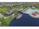 A high angle picture shows the resort style community pool, club house, and water features at 44125 W Cydnee Dr, Maricopa, AZ 85138