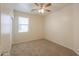 Bright bedroom featuring neutral colors, a ceiling fan, and a window with blinds at 44125 W Cydnee Dr, Maricopa, AZ 85138