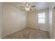 Cozy bedroom with neutral walls, carpet, a ceiling fan, and a window at 44125 W Cydnee Dr, Maricopa, AZ 85138