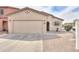 Single-Gathering home with a two-car garage and low-maintenance desert landscaping. in front of the house at 44125 W Cydnee Dr, Maricopa, AZ 85138