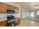 A well-equipped kitchen featuring modern stainless steel appliances and wood cabinets at 44125 W Cydnee Dr, Maricopa, AZ 85138