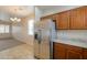 Bright kitchen showcasing stainless steel appliances, oak cabinets and a view to an adjacent living area at 44125 W Cydnee Dr, Maricopa, AZ 85138