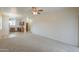 Bright living room featuring neutral carpet flooring and lots of natural light at 44125 W Cydnee Dr, Maricopa, AZ 85138