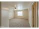 Spacious living room featuring a ceiling fan, plush carpet, and natural light at 44125 W Cydnee Dr, Maricopa, AZ 85138