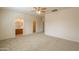 A spacious main bedroom with carpet flooring, walk-in closet, and ensuite bathroom at 44125 W Cydnee Dr, Maricopa, AZ 85138